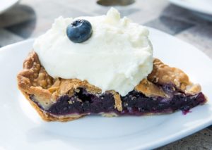 Blueberry pie with whipped cream.