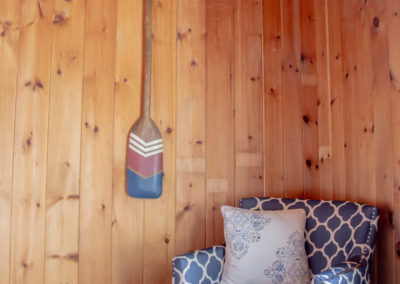 Cabin corner chair and wooden oar art.