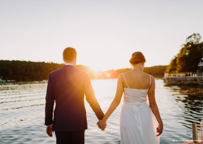 Bride and Groom holding hands at sunset.