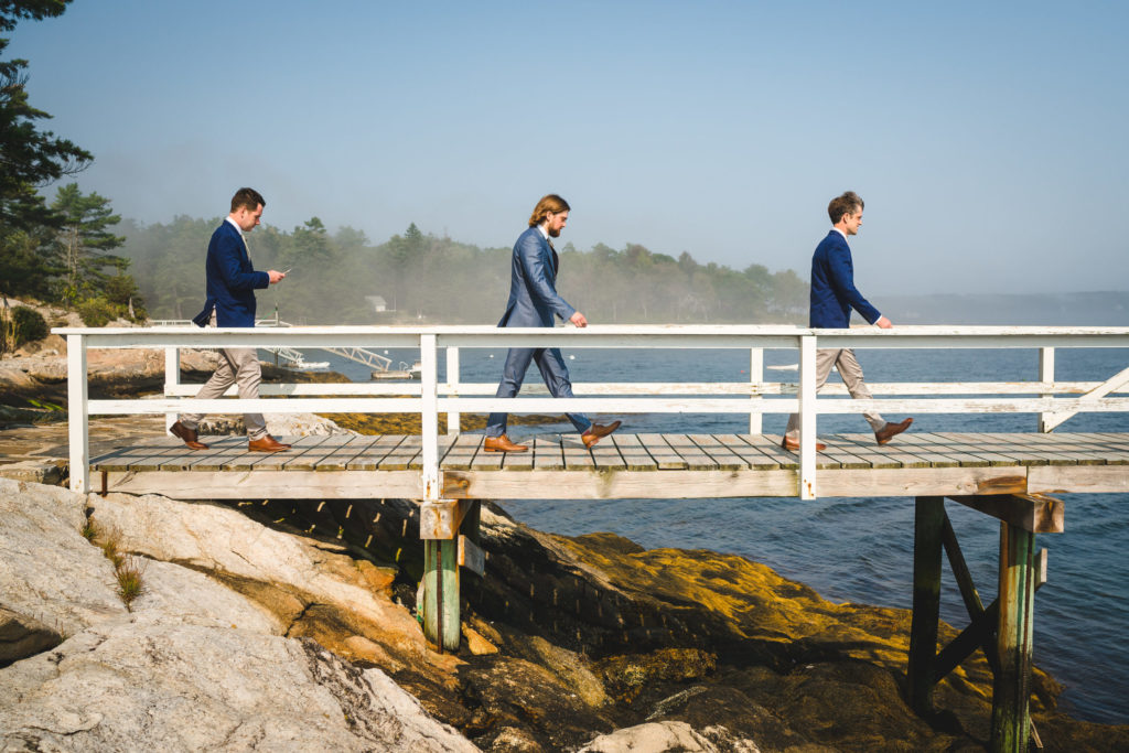 Peter and his groomsmen walking on the pier.