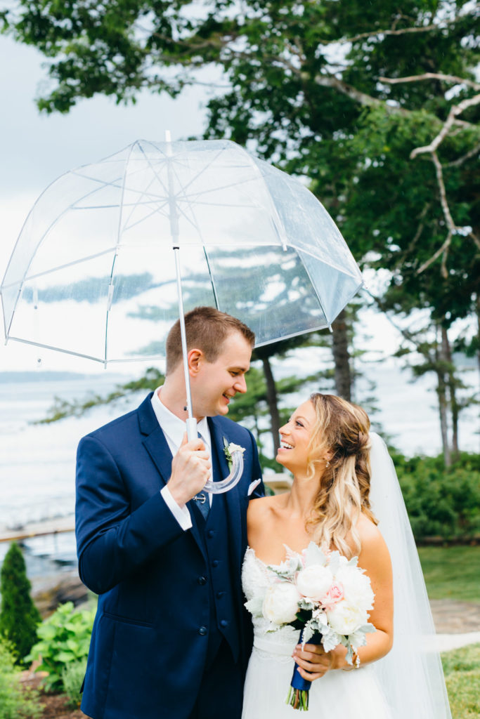 Samantha and Shane posing with an umbrella.