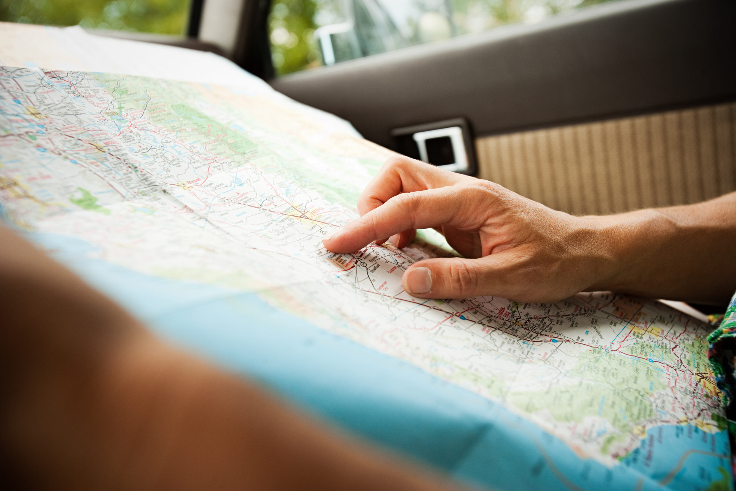Stock image of person looking at a road map.