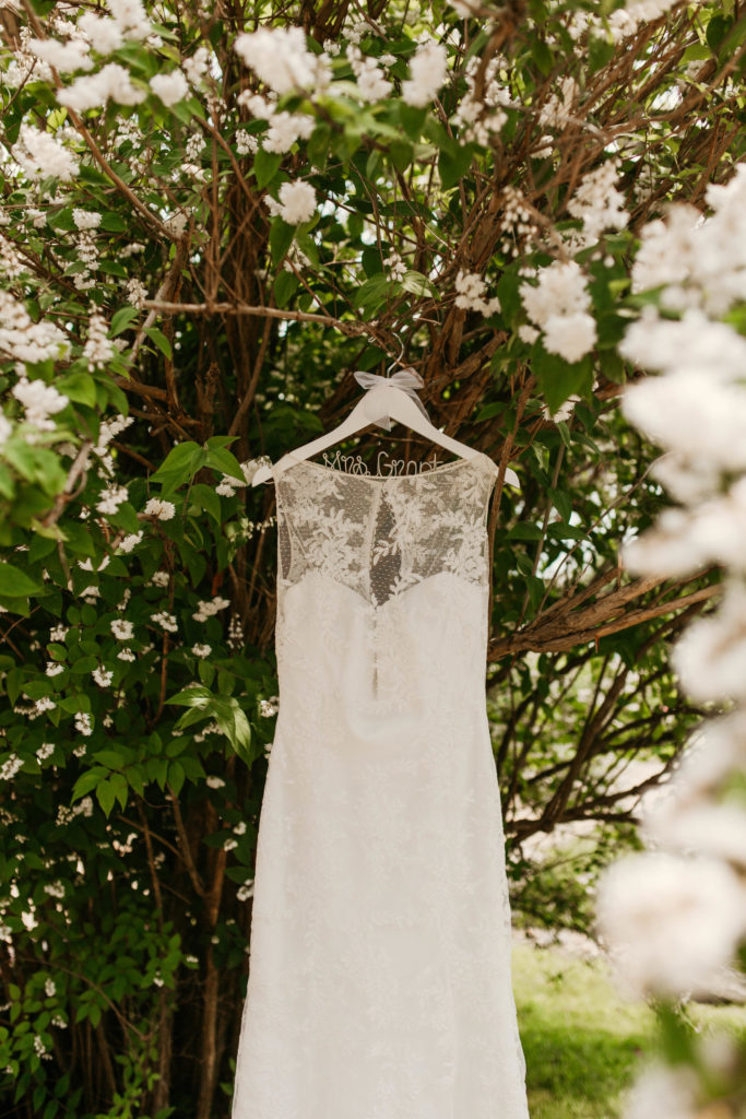 Kylie's wedding dress hanging on a tree