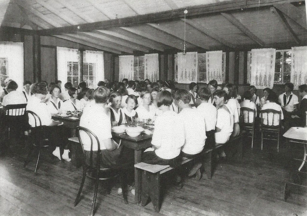 Young women dining together in the hall.