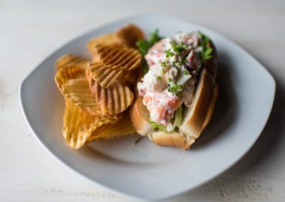 Lobster roll and fried potato chips.