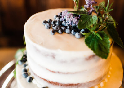Payson & Topher's wedding cake with blueberry toppings.