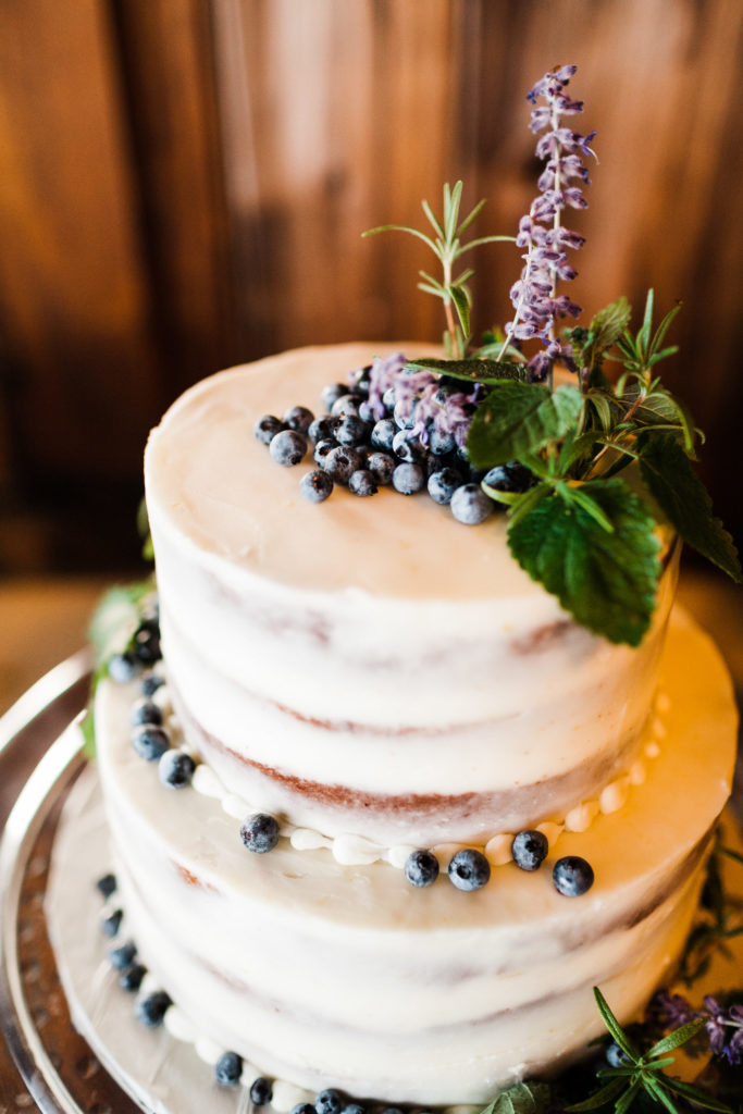 Payson & Topher's wedding cake with blueberry toppings.