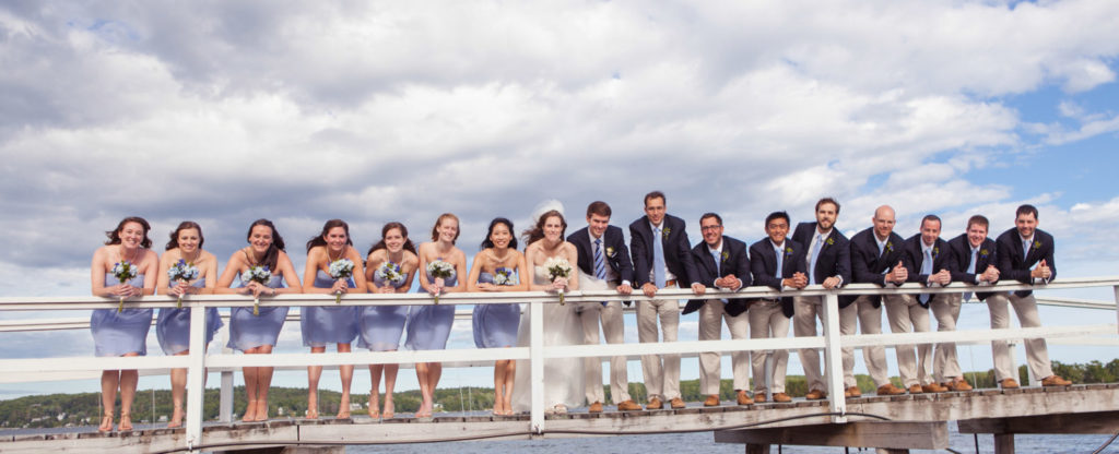 wedding standing on dock for a photograph